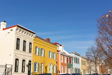 Brightly painted houses on the street of Washington DC neighborhood, USA. Residential houses in close proximity to the Georgetown University.