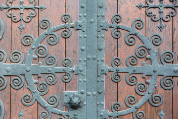 Church door with metal decoration