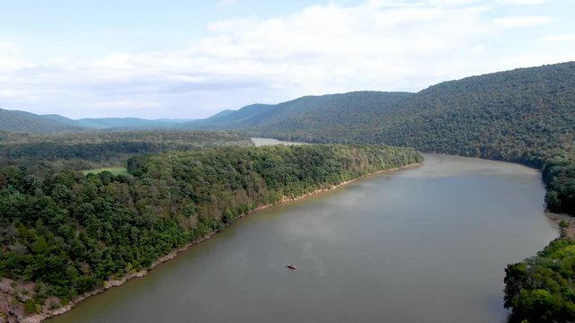 Ascending aerial view of a motorboat on the Raystown Lake Recreational area, a popular outdoor sports and leisure destination in Pennsylvania, offering pristine nature and stunning landscapes.