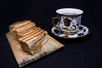 toast with chocolate sprinkles and tea to accompany relaxing time with a black background