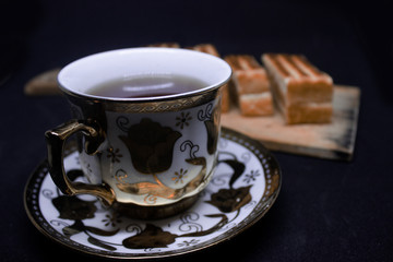 toast with chocolate sprinkles and tea to accompany relaxing time with a black background