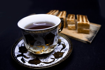 toast with chocolate sprinkles and tea to accompany relaxing time with a black background