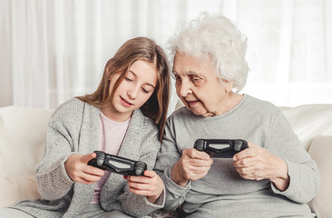 Fototapeta premium Grandmother with granddaughter playing games