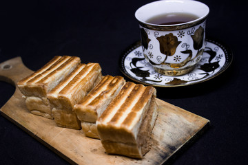 toast with chocolate sprinkles and tea to accompany relaxing time with a black background