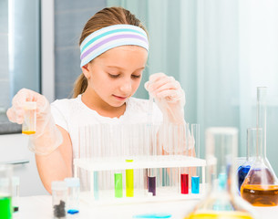 little girl with flasks for chemistry