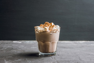 Hot Chocolate drink with marshmallow and cinnamon in old-fashioned glass. Selective focus.