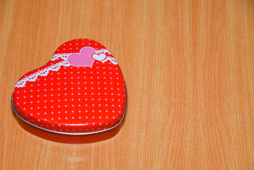 Red Heart shape gift box on wooden table . Valentines Day background , wedding day