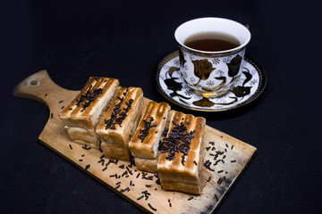 toast with chocolate sprinkles and tea to accompany relaxing time with a black background