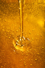 Honey with gold color flows down from a spoon. Healthy food concept. Healthy eating. Diet. Selective focus. Macro.