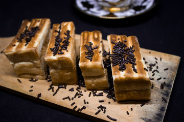 toast with chocolate sprinkles and tea to accompany relaxing time with a black background