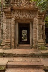 Fototapeta na wymiar Fallen rocks seen through stone temple doorway