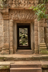 Fototapeta na wymiar Fallen rocks seen through ruined temple doorway