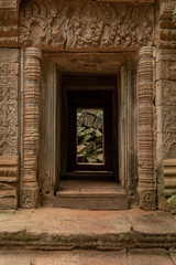Fototapeta na wymiar Fallen rocks seen through stone temple entrance