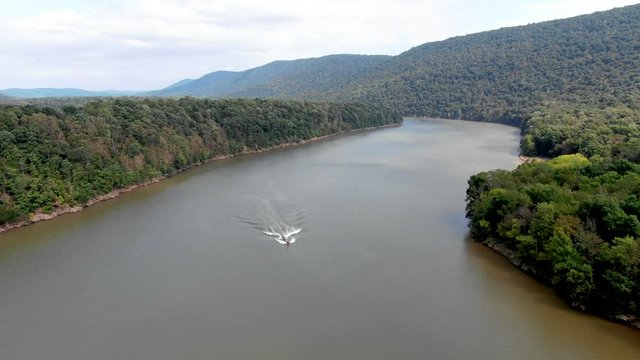 Aerial view of man wakeboarding on lake, water skiing on lake behind a boat, Raystown lake Pennsylvania, USA