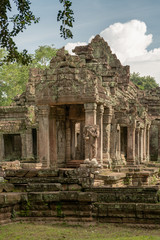 Portico of stone temple framed by trees