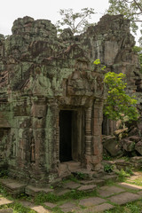 Ruined stone temple portico covered in lichen