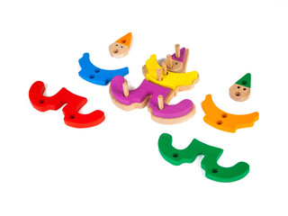 Photo of a wooden toy  children's clown sorter clown-shaped sorter from colorful pieces on a white isolated background. The toy for the development of fine motor child