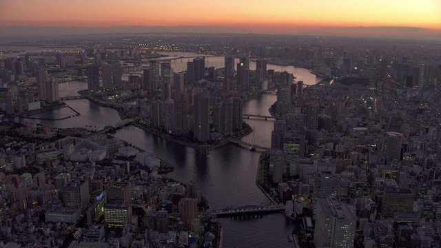 Tokyo, Japan circa-2018.  Flying over Sumida River and Tokyo Bay at dusk.  Shot from helicopter with RED camera.