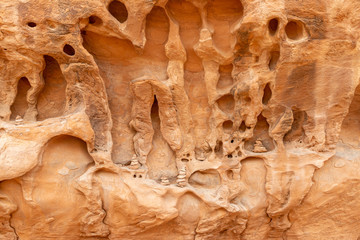 Cairns placed in a weathered wall of sandstone in Devils Garden Trail in Arches National Park, Utah