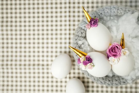 Cute creative photo with easter eggs in the nest, unicorn with flower decor - creative idea for ester party