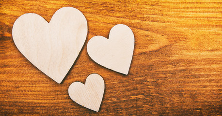 Obraz premium Four wooden hearts on the wooden table