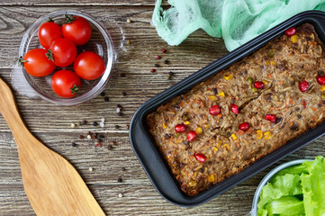 Liver casserole. Useful dish from the liver. Freshly baked pork liver souffle with rice and vegetables on a wooden table. Top view.