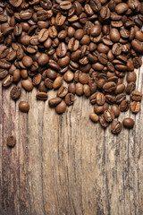 Pile of roasted coffee beans on wood