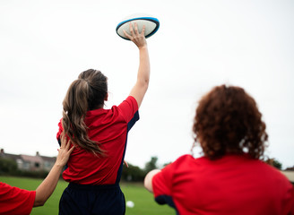 Female rugby player throwing a ball