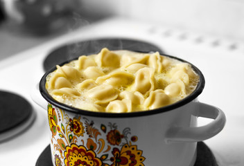 Russian dumplings are cooked in a saucepan. Close up
