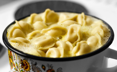 Russian dumplings are cooked in a saucepan. Close up