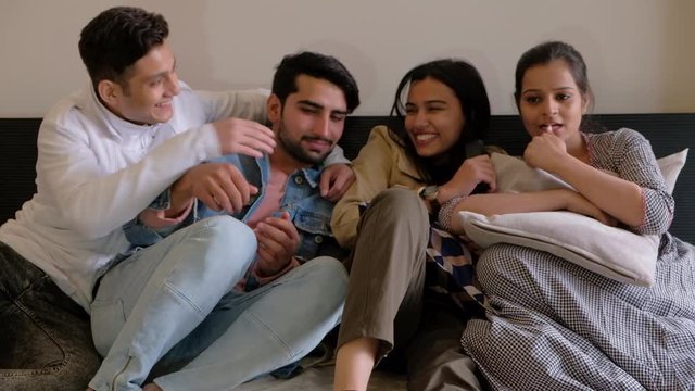 Friends force a friend to watch horror movie film on television even when he is scared and afraid and almost peeing in his pants 