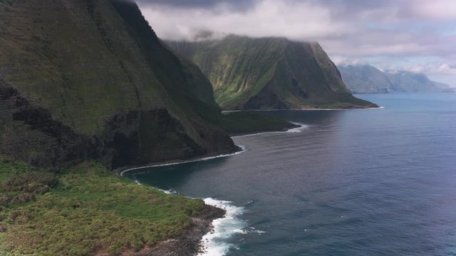 Molokai, Hawaii circa-2018.  Aerial view of Molokai coast with beautiful waterfalls.  Shot with Cineflex and RED Epic-W Helium. 
