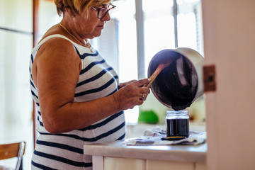 Woman cooking blackberry jam