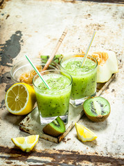 Green smoothie of kiwi, melon and lemon with honey.