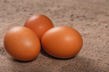 Easter composition. Several eggs on a canvas napkin closeup