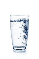 Water falling in glass on isolate background.