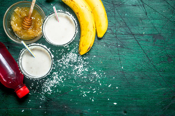 Milk smoothie with banana, strawberry syrup and honey.