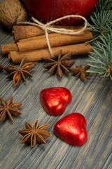 Christmas concept with spices nuts and red apple