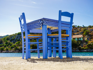 Open cafe outdoor restaurant in Greece on sea shore