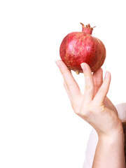 Female hand holds pomegranate fruit
