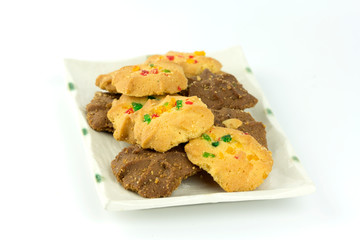 Many variety homemade cookies in plate isolated on white background.