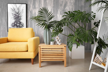 Fototapeta na wymiar Green tropical plants in interior of living room