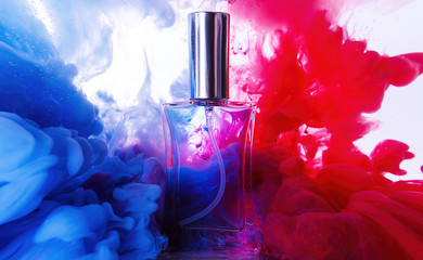 Bottle of perfume in color smoke