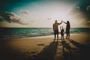 Fototapeta premium happy family with kids play at sunset beach