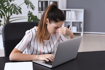 Businesswoman with bad sight working in office