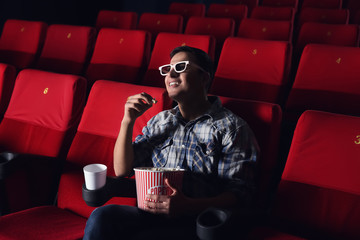 Young man watching movie in cinema