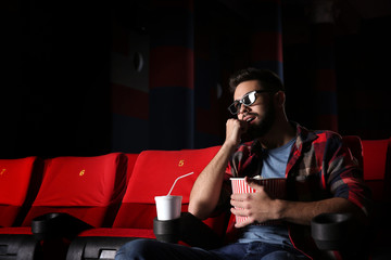 Young man watching movie in cinema