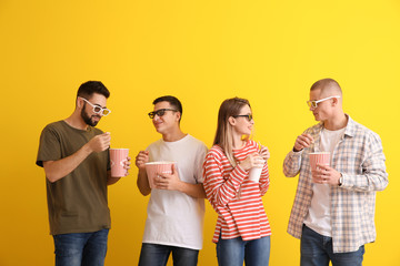 Young people with popcorn discussing movie on color background