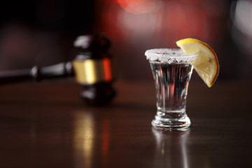 DUI concept. Law gavel, alcohol and car keys on a wooden desk, dark background