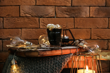 Coffee drink with cookies and garland on wooden table